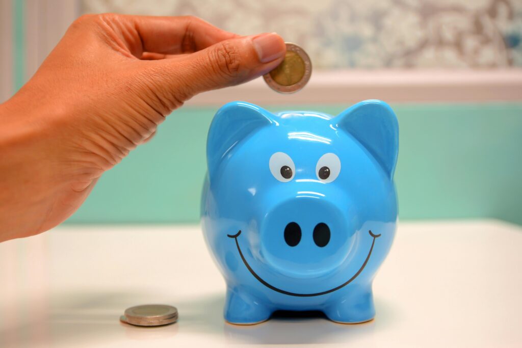 Person Putting Coin in a Piggy Bank Authorized dealer